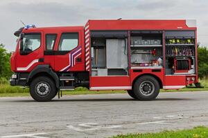 In this captivating scene, a state-of-the-art firetruck, equipped with advanced rescue technology, stands ready with its skilled firefighting team, prepared to intervene and respond rapidly to photo