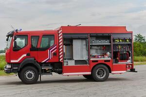 In this captivating scene, a state-of-the-art firetruck, equipped with advanced rescue technology, stands ready with its skilled firefighting team, prepared to intervene and respond rapidly to photo