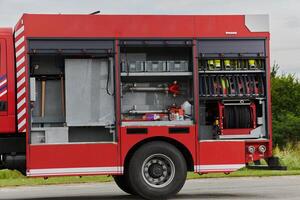 In this captivating scene, a state-of-the-art firetruck, equipped with advanced rescue technology, stands ready with its skilled firefighting team, prepared to intervene and respond rapidly to photo