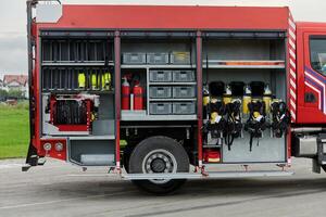 In this captivating scene, a state-of-the-art firetruck, equipped with advanced rescue technology, stands ready with its skilled firefighting team, prepared to intervene and respond rapidly to photo
