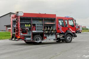 In this captivating scene, a state-of-the-art firetruck, equipped with advanced rescue technology, stands ready with its skilled firefighting team, prepared to intervene and respond rapidly to photo