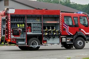 In this captivating scene, a state-of-the-art firetruck, equipped with advanced rescue technology, stands ready with its skilled firefighting team, prepared to intervene and respond rapidly to photo