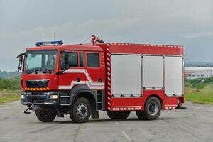 In this captivating scene, a state-of-the-art firetruck, equipped with advanced rescue technology, stands ready with its skilled firefighting team, prepared to intervene and respond rapidly to photo