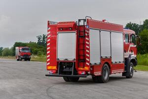 In this captivating scene, a state-of-the-art firetruck, equipped with advanced rescue technology, stands ready with its skilled firefighting team, prepared to intervene and respond rapidly to photo