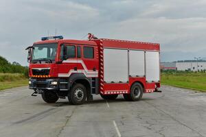 In this captivating scene, a state-of-the-art firetruck, equipped with advanced rescue technology, stands ready with its skilled firefighting team, prepared to intervene and respond rapidly to photo