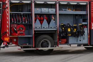 In this captivating scene, a state-of-the-art firetruck, equipped with advanced rescue technology, stands ready with its skilled firefighting team, prepared to intervene and respond rapidly to photo