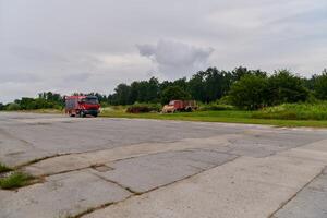In this captivating scene, a state-of-the-art firetruck, equipped with advanced rescue technology, stands ready with its skilled firefighting team, prepared to intervene and respond rapidly to photo