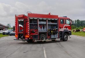 In this captivating scene, a state-of-the-art firetruck, equipped with advanced rescue technology, stands ready with its skilled firefighting team, prepared to intervene and respond rapidly to photo