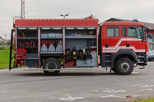 In this captivating scene, a state-of-the-art firetruck, equipped with advanced rescue technology, stands ready with its skilled firefighting team, prepared to intervene and respond rapidly to photo
