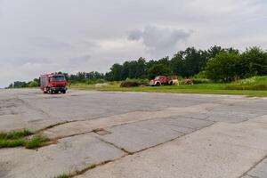 In this captivating scene, a state-of-the-art firetruck, equipped with advanced rescue technology, stands ready with its skilled firefighting team, prepared to intervene and respond rapidly to photo