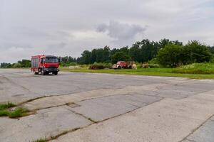 In this captivating scene, a state-of-the-art firetruck, equipped with advanced rescue technology, stands ready with its skilled firefighting team, prepared to intervene and respond rapidly to photo