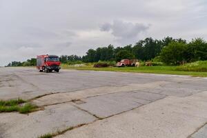 In this captivating scene, a state-of-the-art firetruck, equipped with advanced rescue technology, stands ready with its skilled firefighting team, prepared to intervene and respond rapidly to photo