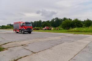 In this captivating scene, a state-of-the-art firetruck, equipped with advanced rescue technology, stands ready with its skilled firefighting team, prepared to intervene and respond rapidly to photo