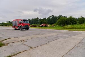 In this captivating scene, a state-of-the-art firetruck, equipped with advanced rescue technology, stands ready with its skilled firefighting team, prepared to intervene and respond rapidly to photo