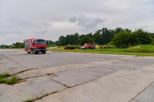 In this captivating scene, a state-of-the-art firetruck, equipped with advanced rescue technology, stands ready with its skilled firefighting team, prepared to intervene and respond rapidly to photo