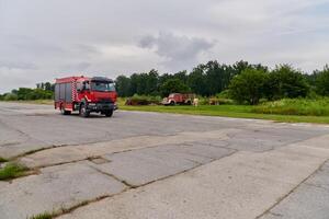In this captivating scene, a state-of-the-art firetruck, equipped with advanced rescue technology, stands ready with its skilled firefighting team, prepared to intervene and respond rapidly to photo