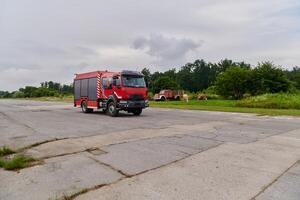 In this captivating scene, a state-of-the-art firetruck, equipped with advanced rescue technology, stands ready with its skilled firefighting team, prepared to intervene and respond rapidly to photo