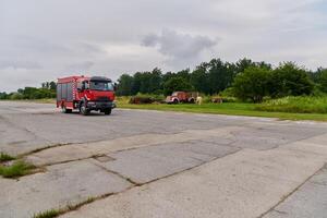 In this captivating scene, a state-of-the-art firetruck, equipped with advanced rescue technology, stands ready with its skilled firefighting team, prepared to intervene and respond rapidly to photo