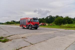 In this captivating scene, a state-of-the-art firetruck, equipped with advanced rescue technology, stands ready with its skilled firefighting team, prepared to intervene and respond rapidly to photo