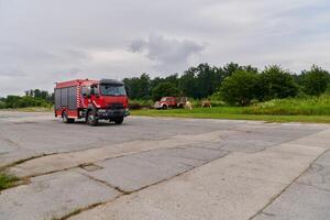 In this captivating scene, a state-of-the-art firetruck, equipped with advanced rescue technology, stands ready with its skilled firefighting team, prepared to intervene and respond rapidly to photo