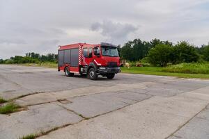 In this captivating scene, a state-of-the-art firetruck, equipped with advanced rescue technology, stands ready with its skilled firefighting team, prepared to intervene and respond rapidly to photo