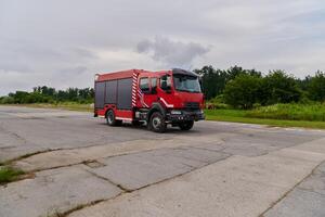 In this captivating scene, a state-of-the-art firetruck, equipped with advanced rescue technology, stands ready with its skilled firefighting team, prepared to intervene and respond rapidly to photo