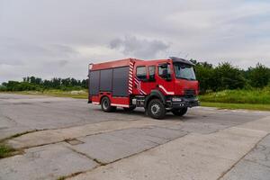 In this captivating scene, a state-of-the-art firetruck, equipped with advanced rescue technology, stands ready with its skilled firefighting team, prepared to intervene and respond rapidly to photo