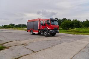 In this captivating scene, a state-of-the-art firetruck, equipped with advanced rescue technology, stands ready with its skilled firefighting team, prepared to intervene and respond rapidly to photo