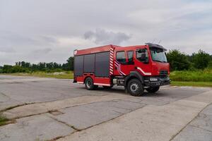 In this captivating scene, a state-of-the-art firetruck, equipped with advanced rescue technology, stands ready with its skilled firefighting team, prepared to intervene and respond rapidly to photo