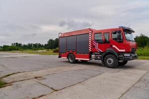 In this captivating scene, a state-of-the-art firetruck, equipped with advanced rescue technology, stands ready with its skilled firefighting team, prepared to intervene and respond rapidly to photo