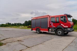 In this captivating scene, a state-of-the-art firetruck, equipped with advanced rescue technology, stands ready with its skilled firefighting team, prepared to intervene and respond rapidly to photo