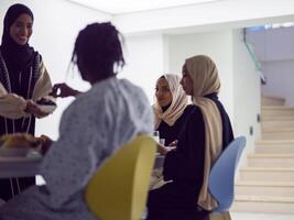 A woman in a hijab extends a platter of dates to her diverse family, creating a scene of unity and joy as they come together to break their fast during the holy month of Ramadan, symbolizing the photo