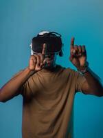 Immersed in a digital realm, an African American man navigates the virtual landscape with a VR goggles, using tactile gestures to interact with virtual objects, showcasing a harmonious blend of photo