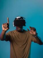 Immersed in a digital realm, an African American man navigates the virtual landscape with a VR goggles, using tactile gestures to interact with virtual objects, showcasing a harmonious blend of photo