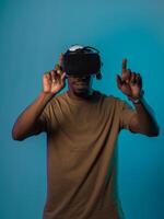 Immersed in a digital realm, an African American man navigates the virtual landscape with a VR goggles, using tactile gestures to interact with virtual objects, showcasing a harmonious blend of photo