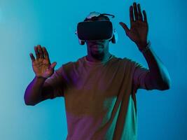 Immersed in a digital realm, an African American man navigates the virtual landscape with a VR goggles, using tactile gestures to interact with virtual objects, showcasing a harmonious blend of photo