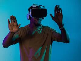 Immersed in a digital realm, an African American man navigates the virtual landscape with a VR goggles, using tactile gestures to interact with virtual objects, showcasing a harmonious blend of photo