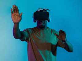 Immersed in a digital realm, an African American man navigates the virtual landscape with a VR goggles, using tactile gestures to interact with virtual objects, showcasing a harmonious blend of photo