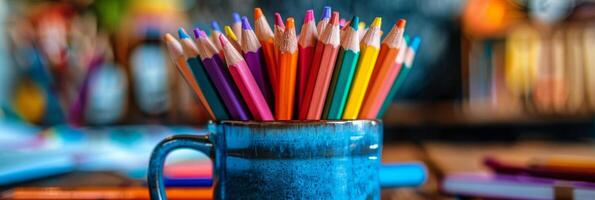 Assortment of Colored Pencils Arranged in Blue Ceramic Mug photo