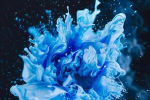 Photo of a Dynamic Explosion of Blue Paint Against a Dark Background