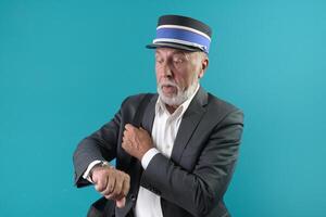 The train conductor warns the passenger about the time of departure of the train. On a blue background photo