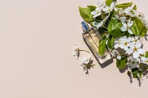 An elegant bottle of cosmetic spray or perfume on a light background among the tree branches. Sunlight. copy space. top view photo
