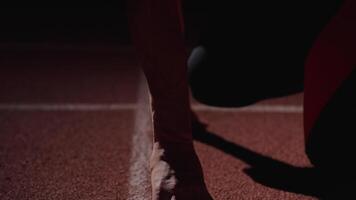 Closeup Of Hands And Face Of Professional Runner In Low Start Position On Running Track In Stadium video