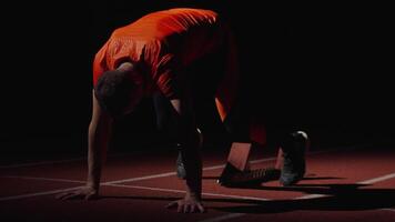 Sprinter Runner Preparing To Start Of Sprint Running, Man Putting Feet Into Starting Blocks video