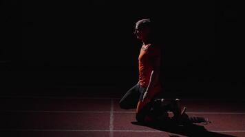 Sportsman Standing In Low Start Position, Leaning On Starting Blocks, Run Workout Of Sprinter video