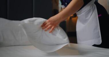 Woman Maid In Uniform And White Apron Making Bed In Bedroom, Closeup View Of Pillow video