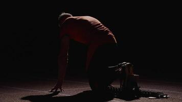 Runner In Low Start Position, Back View, Athletic Man Leaning On Pressure-Sensitive Starting Blocks video