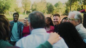 Happy multigenerational group of people with different ethnicities having fun in a public park - People diversity concept video