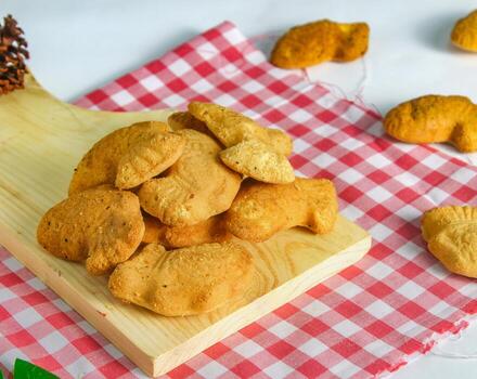 fish-shaped bahulu cake on a wooden cutting board. similar to a madeleine cake but in the shape of a fish photo