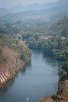 An aerial view of the dam-caused canal in Thailand's national park, with a mountain the background. Bird eye view. photo